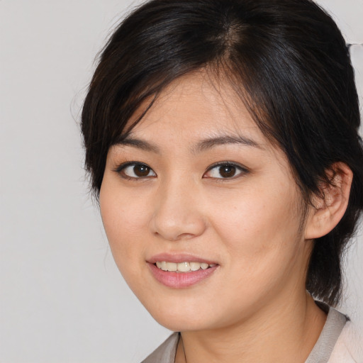 Joyful asian young-adult female with medium  brown hair and brown eyes