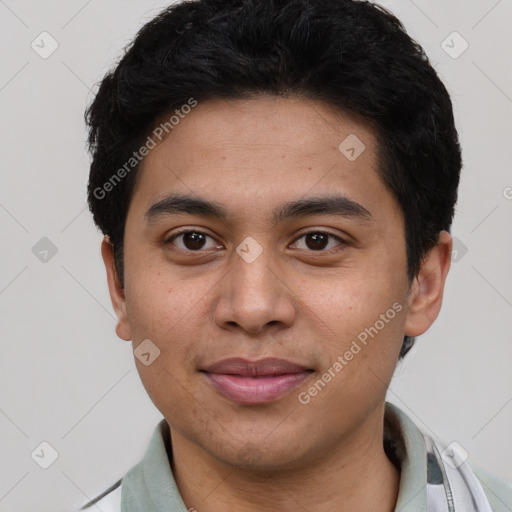 Joyful latino young-adult male with short  black hair and brown eyes