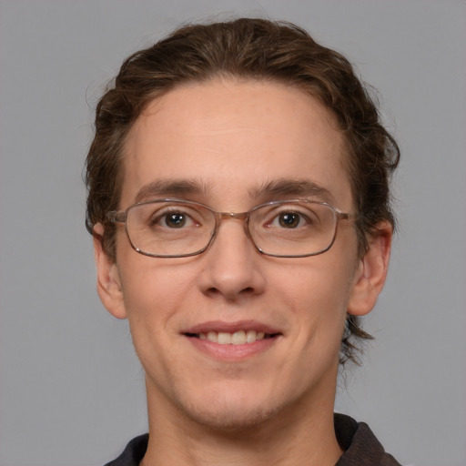 Joyful white adult male with short  brown hair and grey eyes