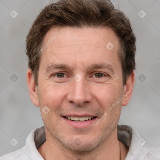 Joyful white adult male with short  brown hair and grey eyes