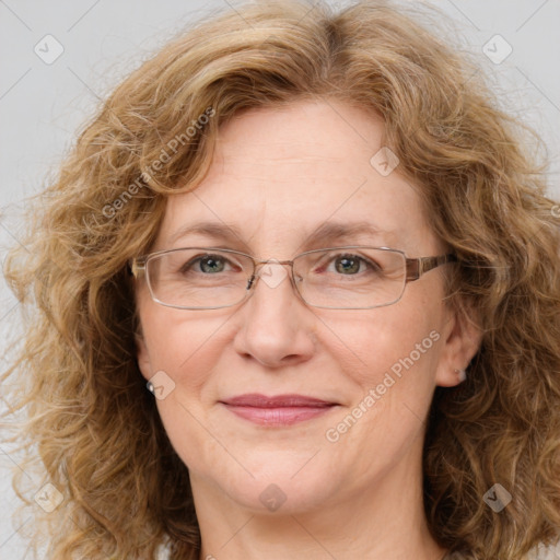 Joyful white adult female with medium  brown hair and blue eyes