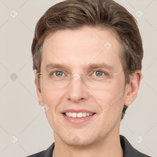 Joyful white adult male with short  brown hair and grey eyes