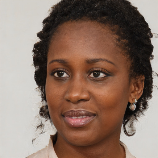 Joyful black young-adult female with medium  brown hair and brown eyes