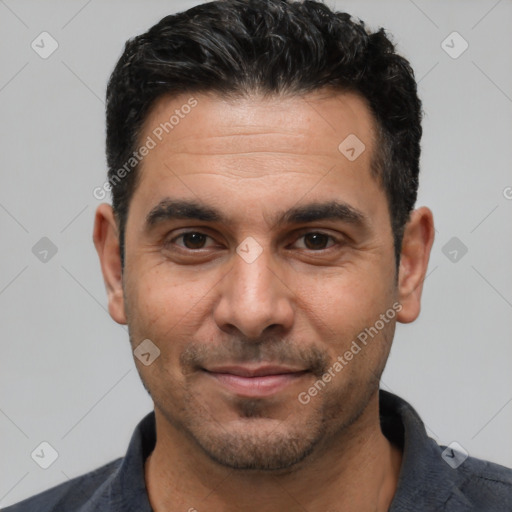 Joyful white young-adult male with short  black hair and brown eyes