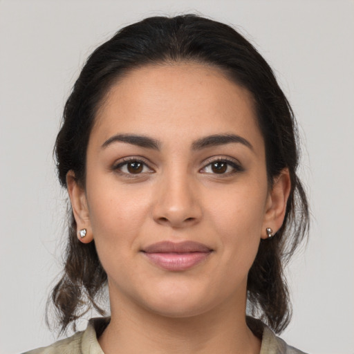 Joyful latino young-adult female with medium  brown hair and brown eyes