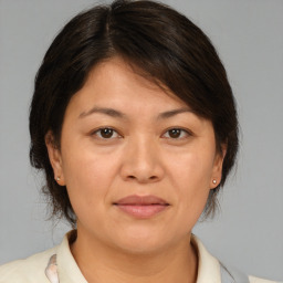 Joyful white adult female with medium  brown hair and brown eyes