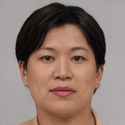 Joyful asian adult female with short  brown hair and brown eyes