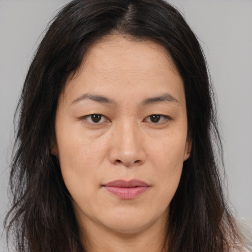 Joyful asian young-adult female with long  brown hair and brown eyes