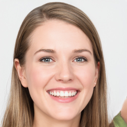 Joyful white young-adult female with long  brown hair and grey eyes