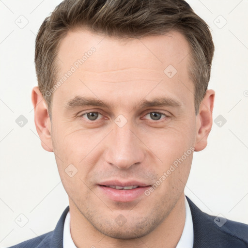 Joyful white young-adult male with short  brown hair and grey eyes