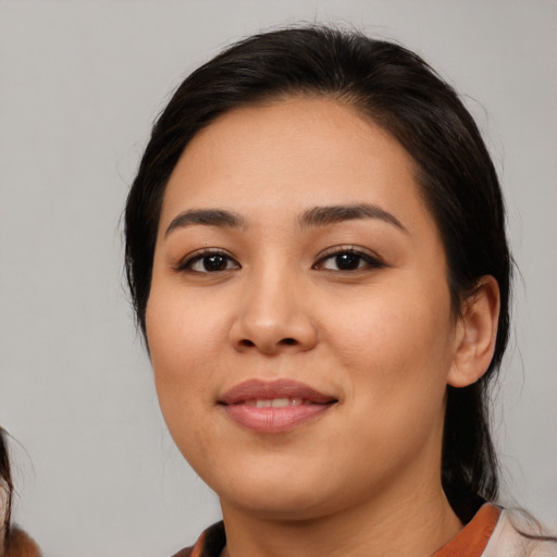 Joyful latino young-adult female with medium  black hair and brown eyes