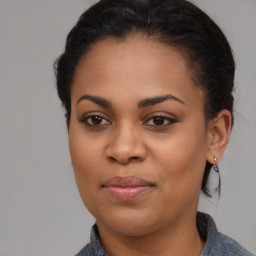 Joyful black young-adult female with medium  brown hair and brown eyes