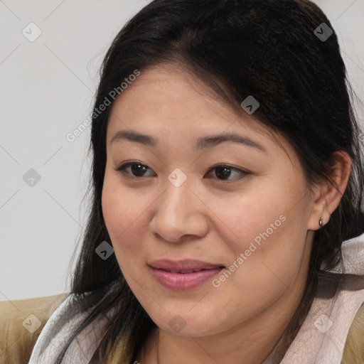 Joyful asian young-adult female with long  brown hair and brown eyes