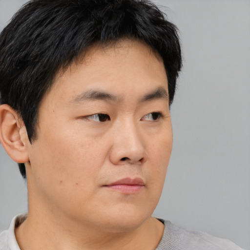 Neutral asian young-adult male with short  brown hair and brown eyes