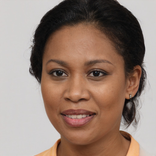 Joyful black young-adult female with medium  brown hair and brown eyes