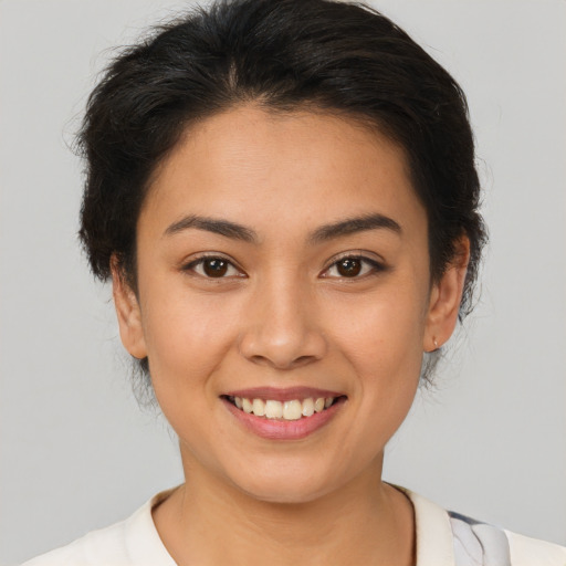 Joyful latino young-adult female with short  brown hair and brown eyes