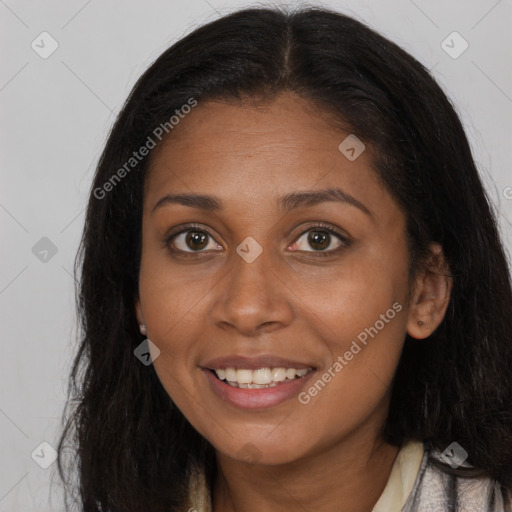 Joyful black young-adult female with long  brown hair and brown eyes