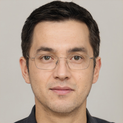 Joyful white adult male with short  black hair and brown eyes