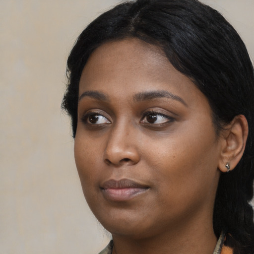 Neutral black young-adult female with medium  black hair and brown eyes