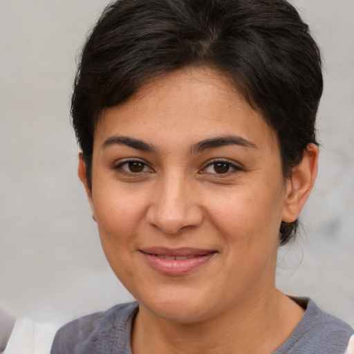 Joyful latino young-adult female with short  brown hair and brown eyes