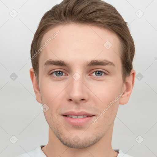 Joyful white young-adult male with short  brown hair and grey eyes