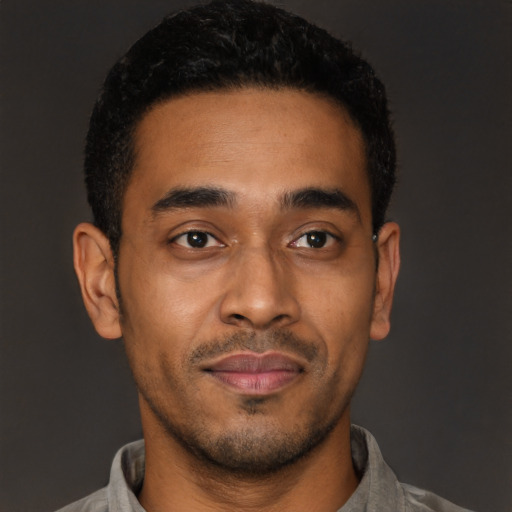 Joyful latino young-adult male with short  brown hair and brown eyes