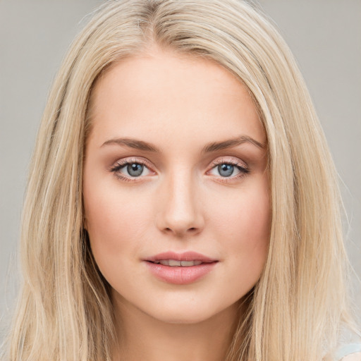 Joyful white young-adult female with long  brown hair and blue eyes