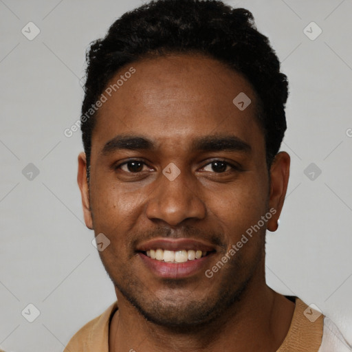 Joyful black young-adult male with short  black hair and brown eyes