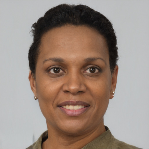 Joyful black adult female with short  brown hair and brown eyes