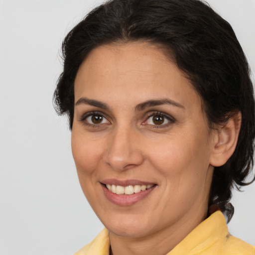 Joyful white adult female with medium  brown hair and brown eyes