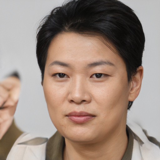 Joyful asian young-adult female with short  brown hair and brown eyes