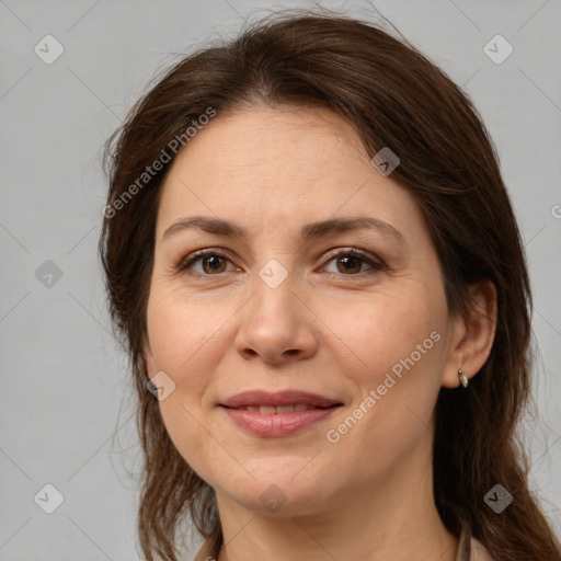 Joyful white adult female with medium  brown hair and brown eyes