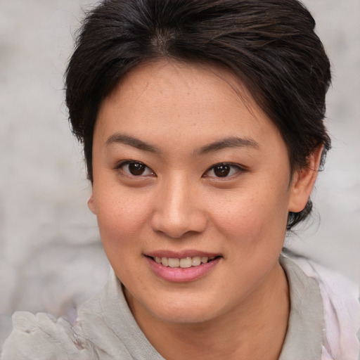 Joyful asian young-adult female with medium  brown hair and brown eyes