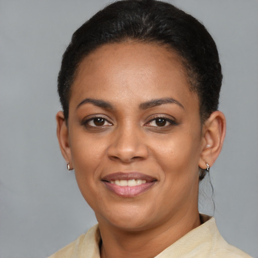 Joyful latino young-adult female with short  black hair and brown eyes
