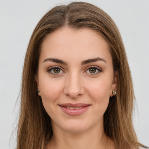 Joyful white young-adult female with long  brown hair and green eyes