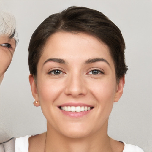 Joyful white young-adult female with short  brown hair and brown eyes