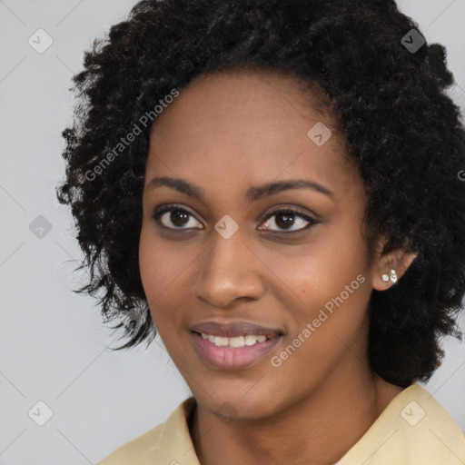 Joyful black young-adult female with long  black hair and brown eyes