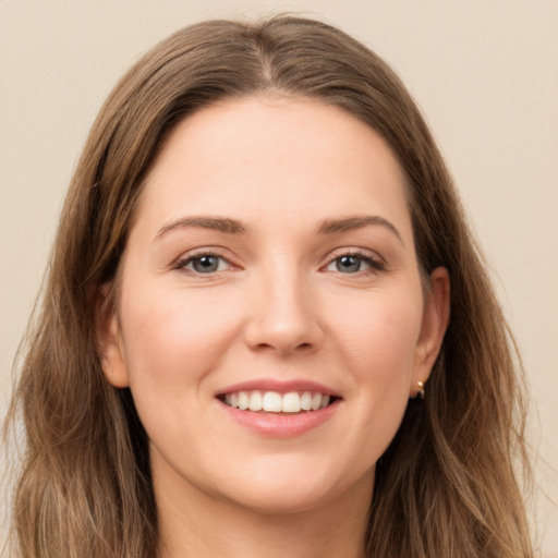 Joyful white young-adult female with long  brown hair and grey eyes