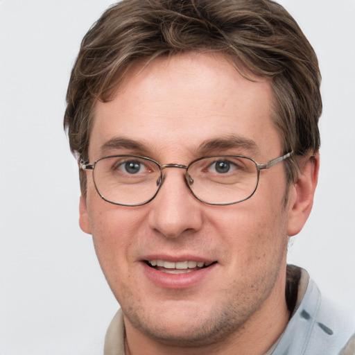 Joyful white adult male with short  brown hair and grey eyes