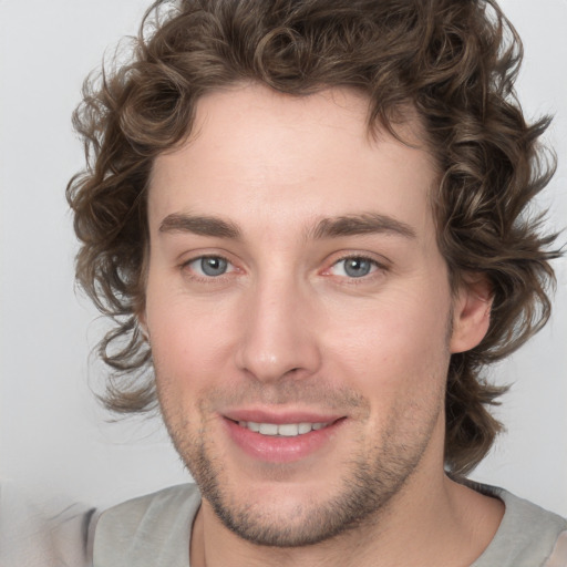 Joyful white young-adult male with medium  brown hair and brown eyes