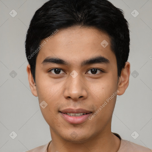 Joyful asian young-adult male with short  black hair and brown eyes