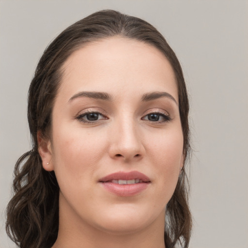 Joyful white young-adult female with long  brown hair and grey eyes