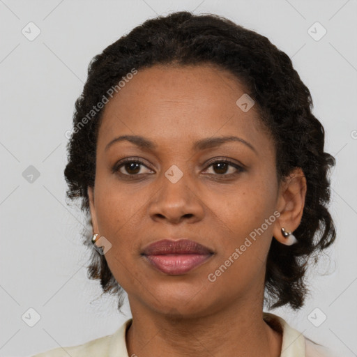 Joyful black adult female with medium  brown hair and brown eyes