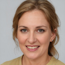 Joyful white adult female with medium  brown hair and brown eyes