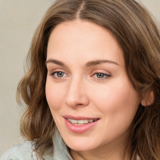 Joyful white young-adult female with medium  brown hair and green eyes