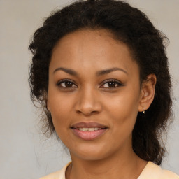 Joyful black young-adult female with medium  brown hair and brown eyes