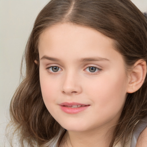 Joyful white child female with long  brown hair and brown eyes