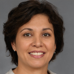 Joyful white adult female with medium  brown hair and brown eyes