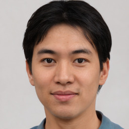 Joyful asian young-adult male with short  black hair and brown eyes