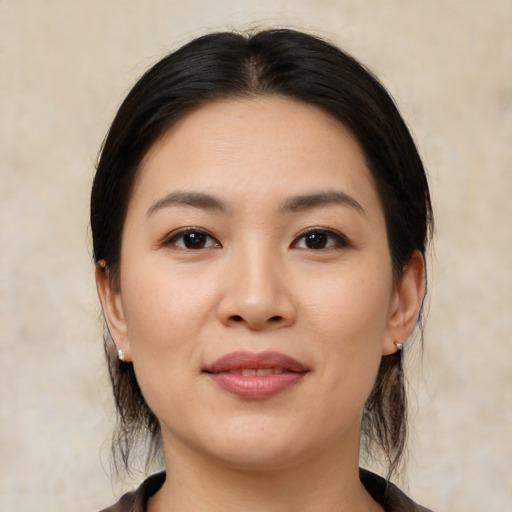 Joyful white young-adult female with medium  black hair and brown eyes